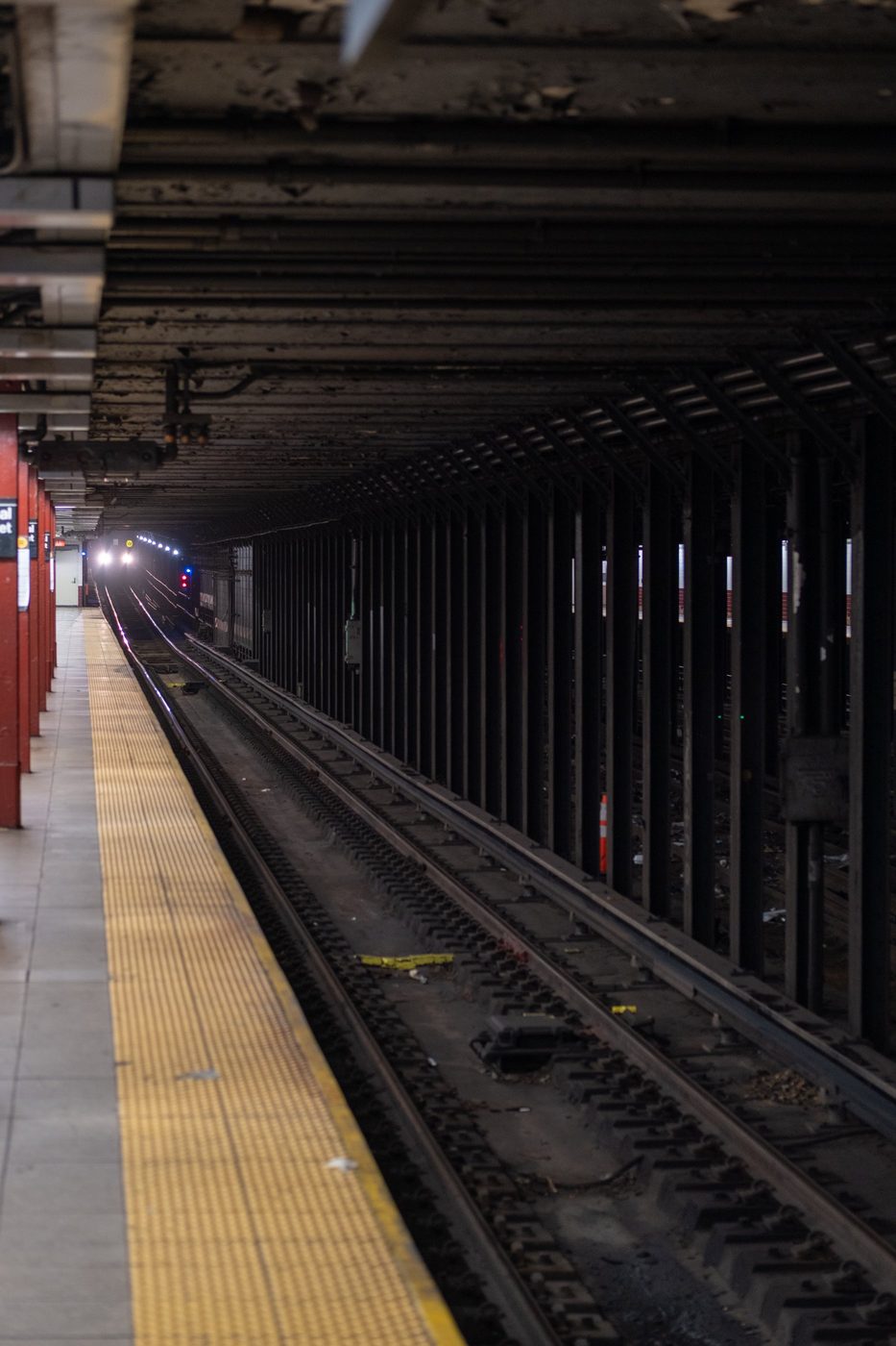 Subway train approaching in a dark tunnel, New York