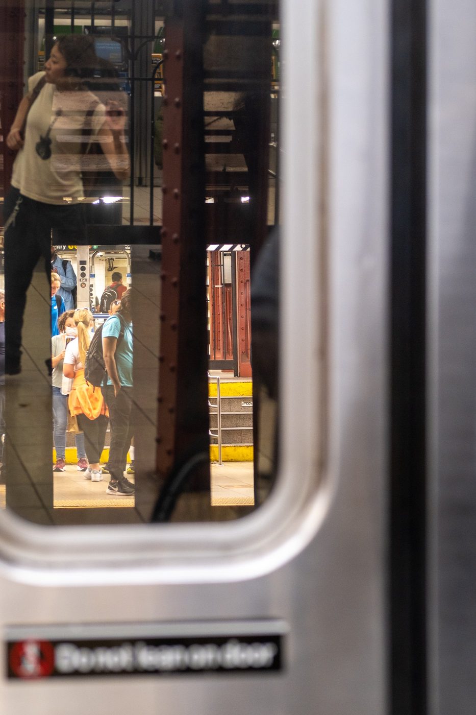 Reflection of the subway platform in a train door's window, New York