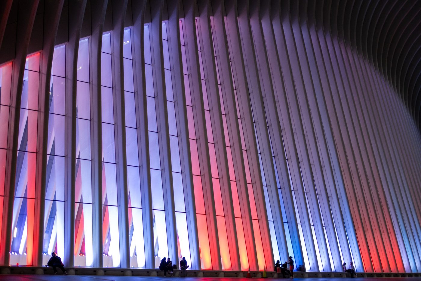 Ribs of the Oculus interior lit up in blue and red, New York
