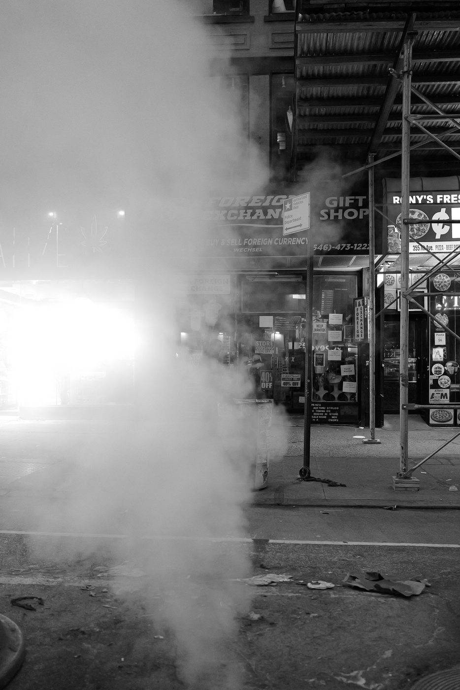 Thick white steam in front of a currency exchange storefront, New York