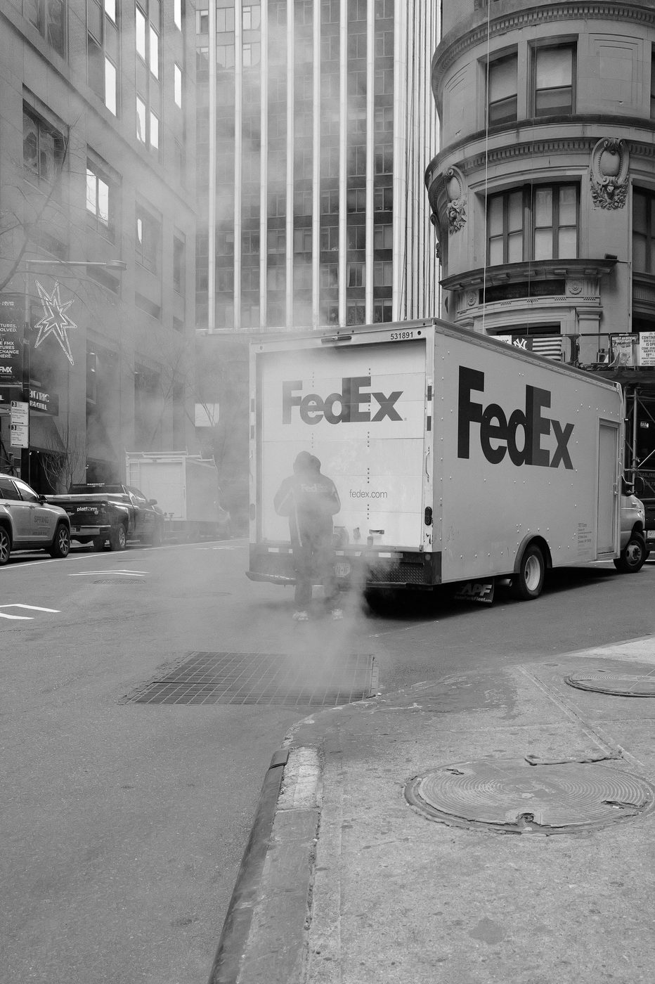 FedEx truck in the steam, delivery driver opening the rear doors, New York