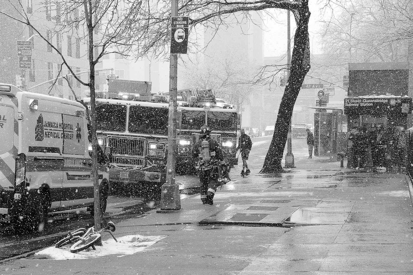 Fire trucks and an ambulance lined up in the snow, New York