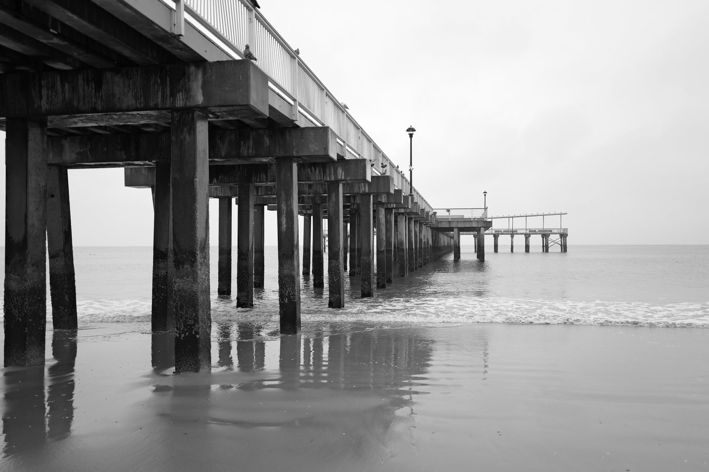 Low-angle view of the wooden pier from the beach, New York