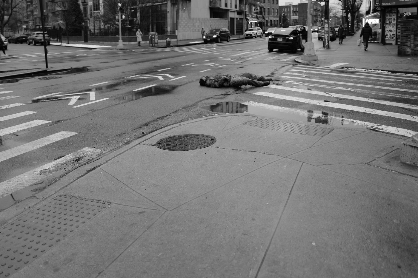 Silhouette stretched across a wet crosswalk, New York