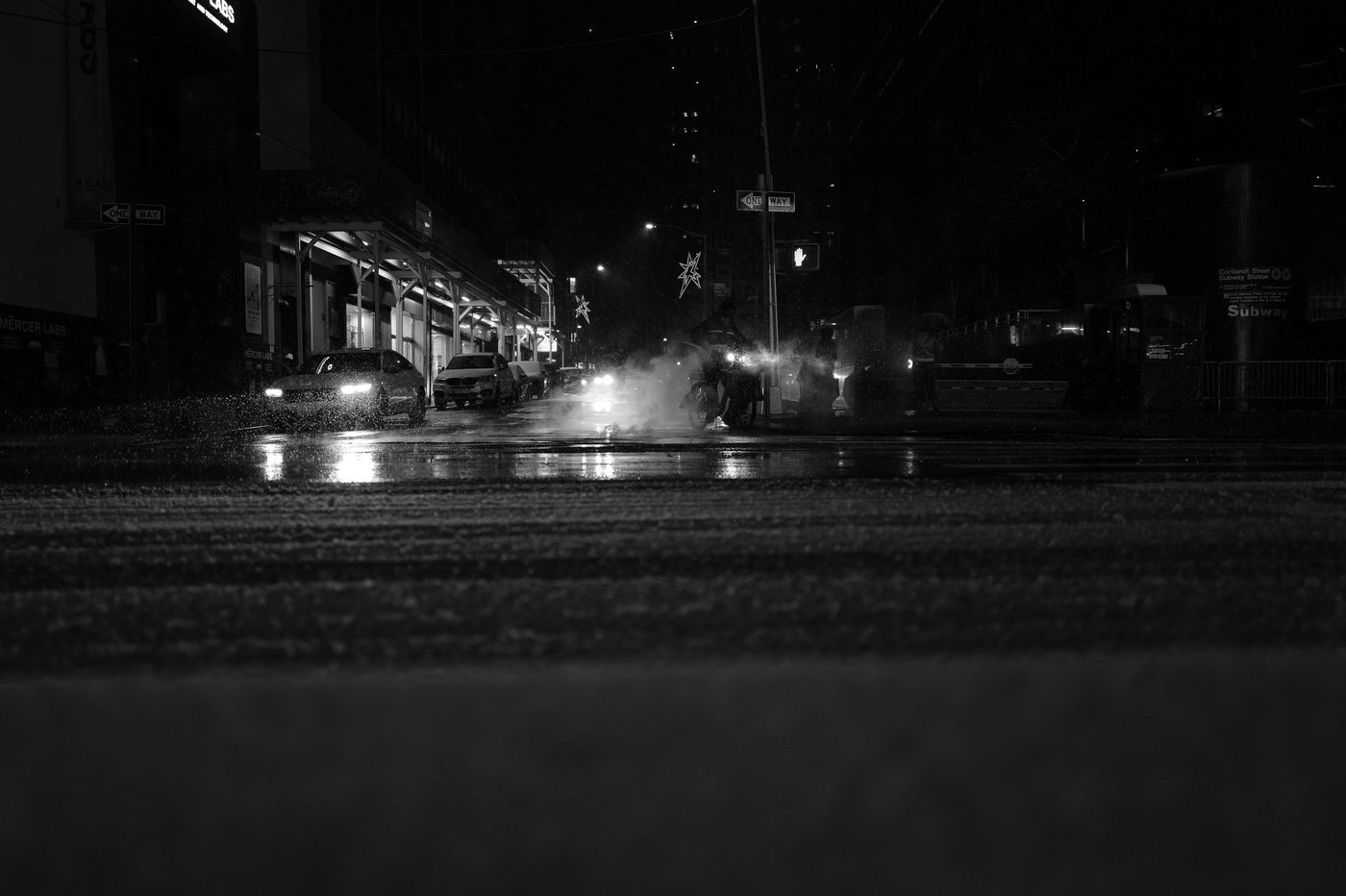 Wet nighttime street near Cortlandt Street station, New York
