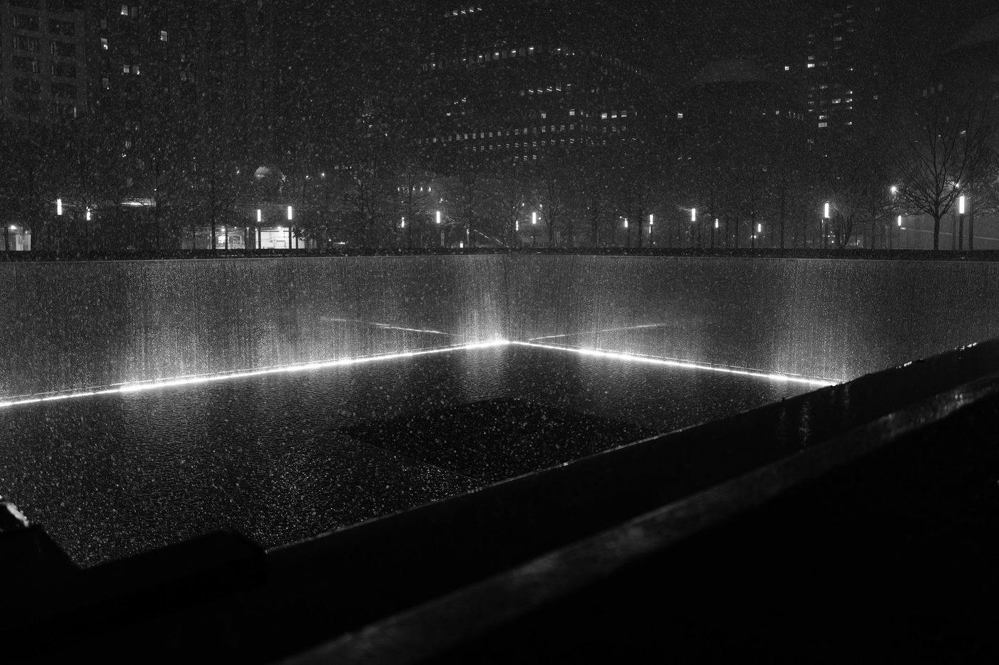 9/11 Memorial pool under the nighttime rain, New York