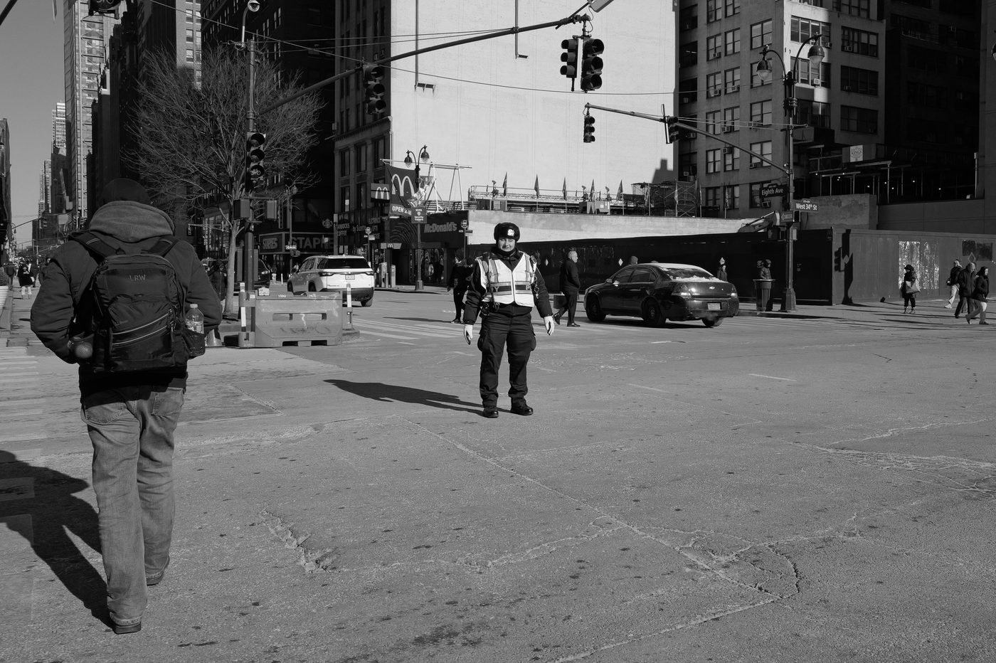 Traffic officer stationed in the middle of an intersection on 34th Street, New York
