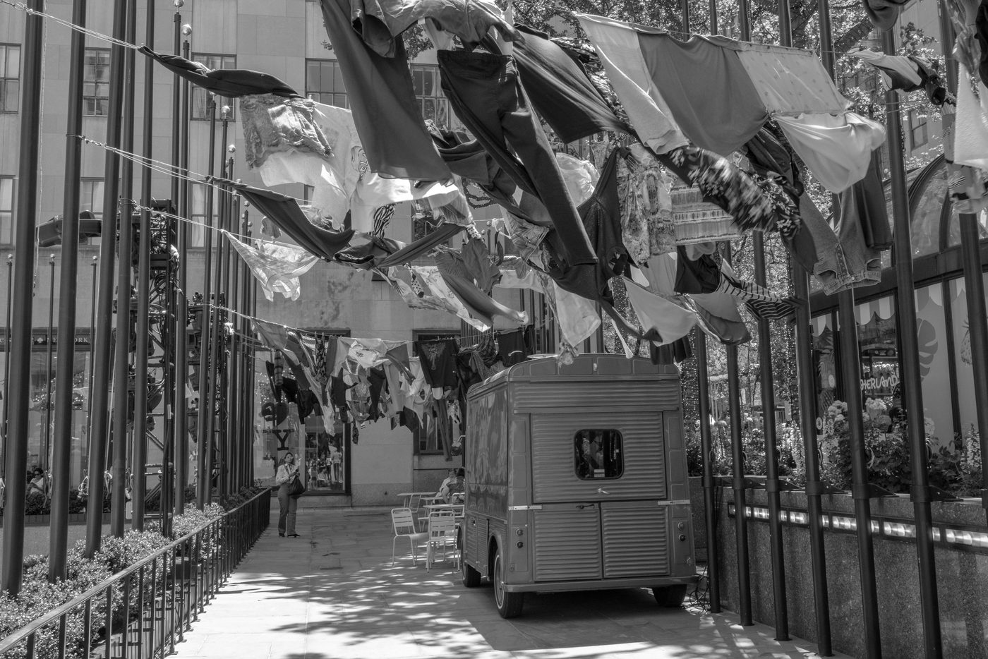 Colorful clothes hanging above a vintage food truck, New York