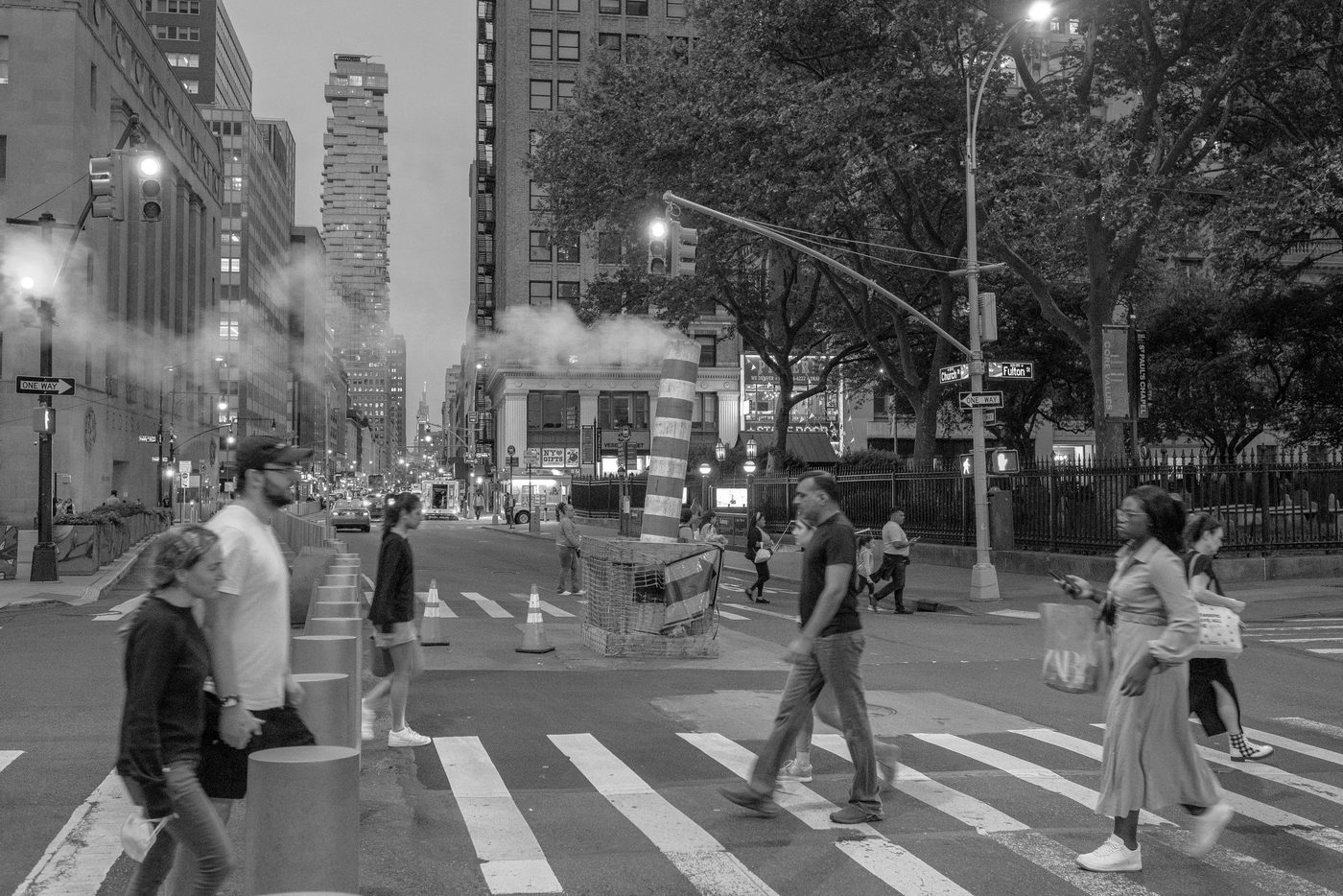 Group of passersby crossing the street at dusk in blurred motion, New York