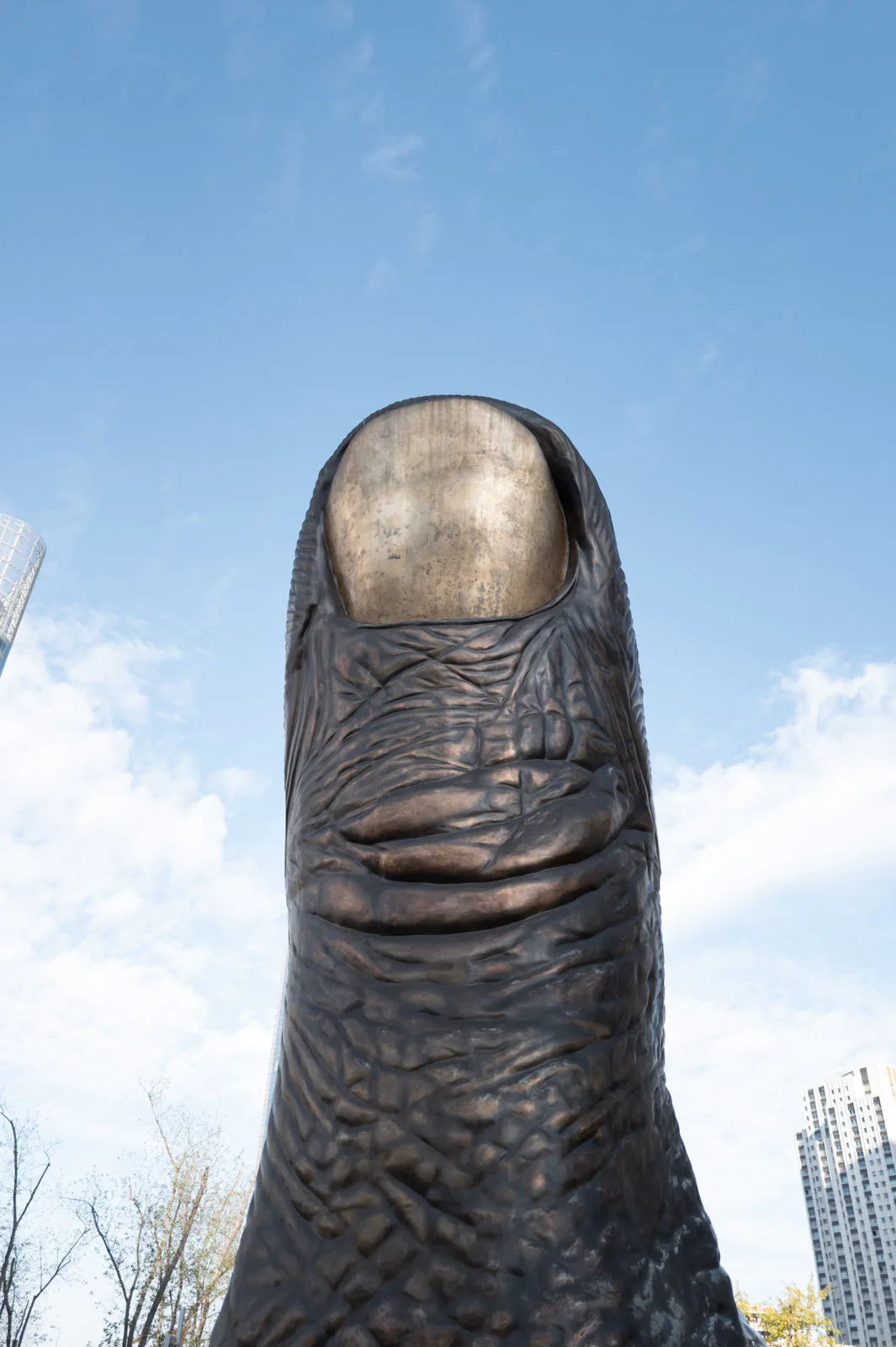 César’s giant Thumb seen from below against the blue sky, Paris