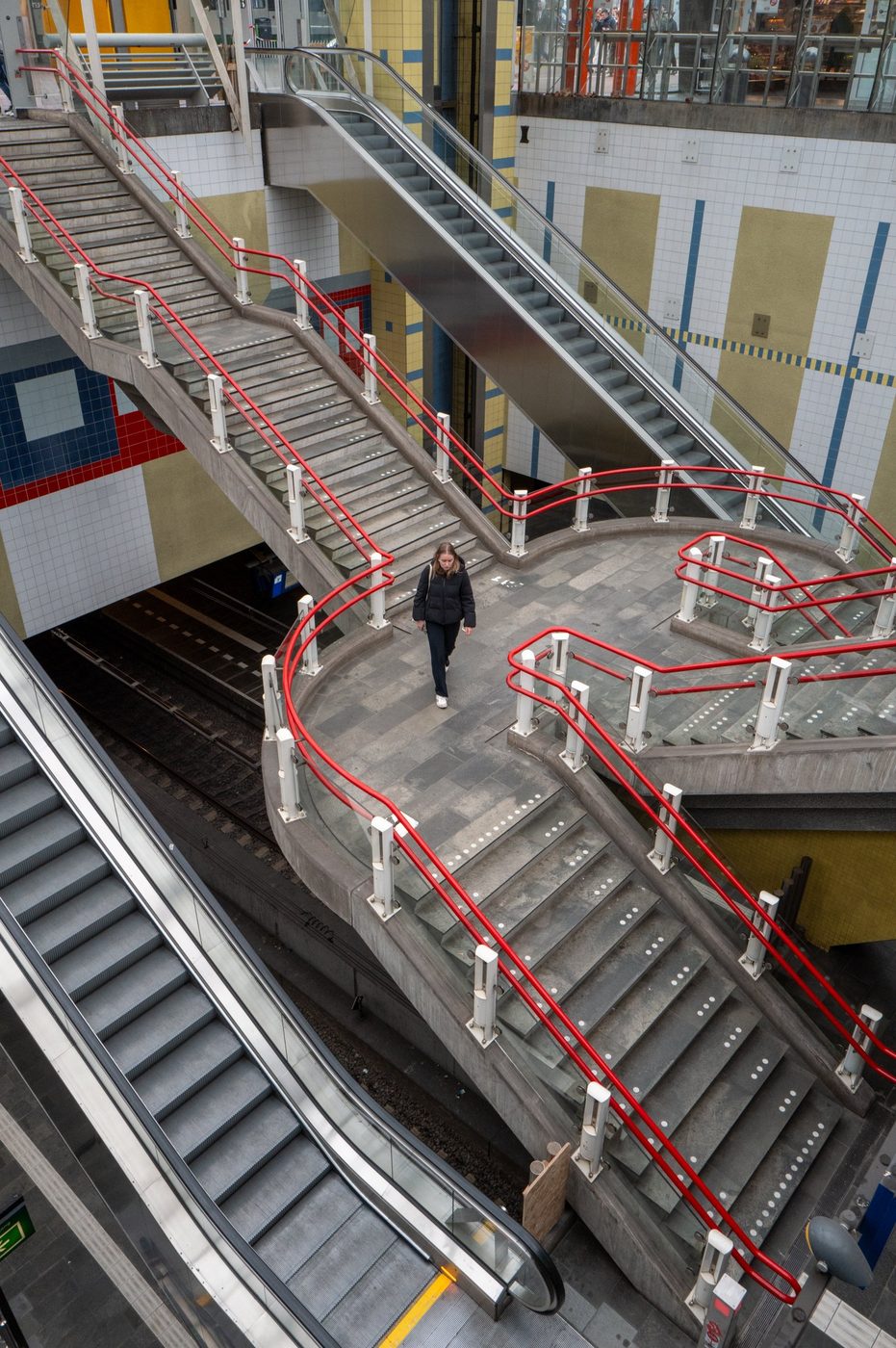 Heart-shaped staircase with red railings in the metro, Rotterdam