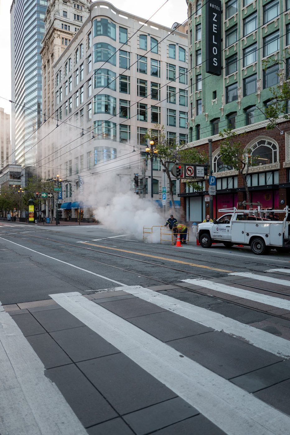 Steam from a street pipe spreading across the road near the Hotel Zelos, San Francisco