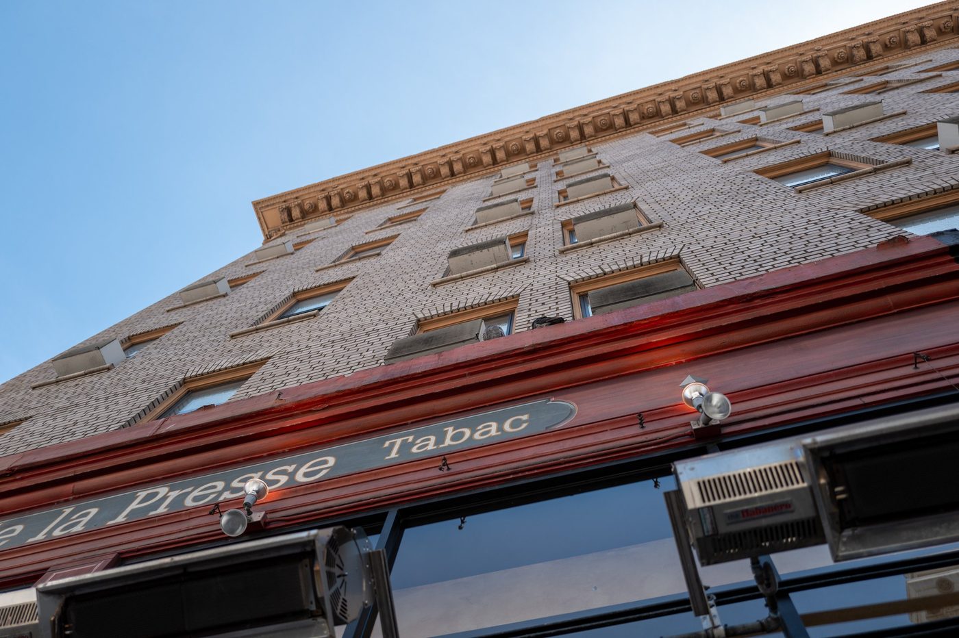 Low-angle view of the brick façade of the La Presse tobacco bar, San Francisco