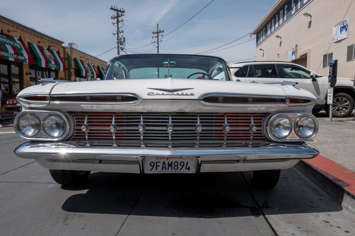 Chrome grille of a vintage white Chevrolet, close-up low-angle shot, San Francisco