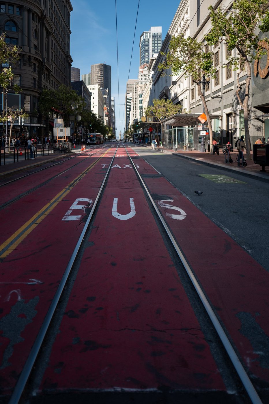 Bus-only lane painted red sinking into Market Street, San Francisco