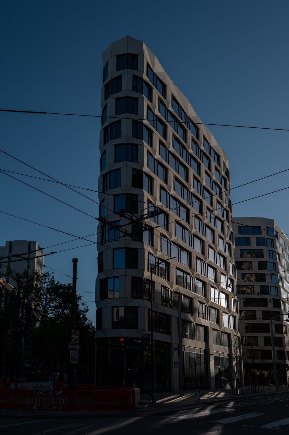 Modern building with a pleated glass façade, fading evening light, San Francisco