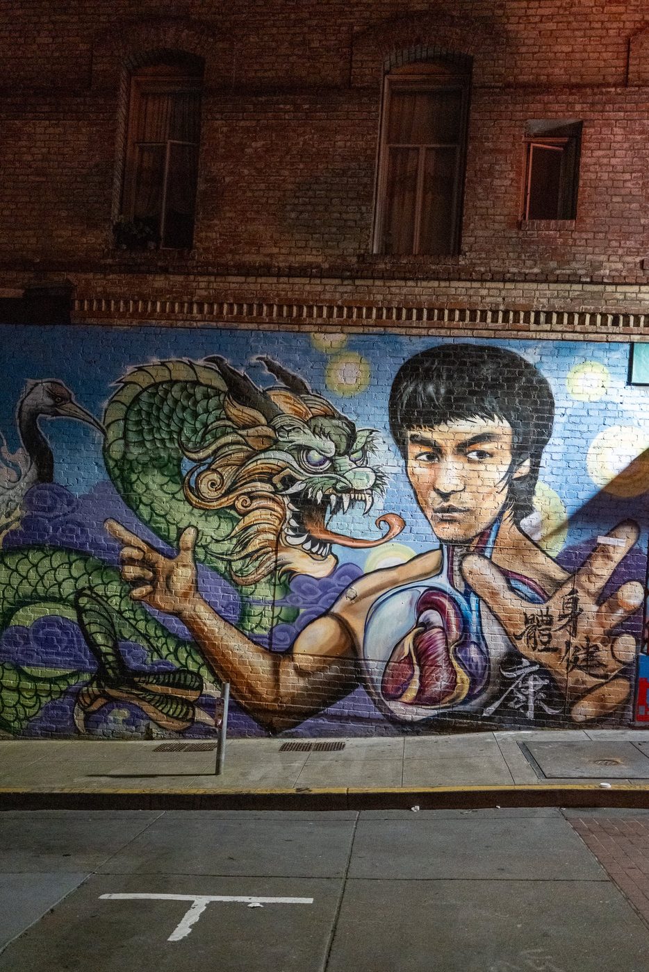 Close-up of the Bruce Lee mural, fist raised facing the dragon, San Francisco