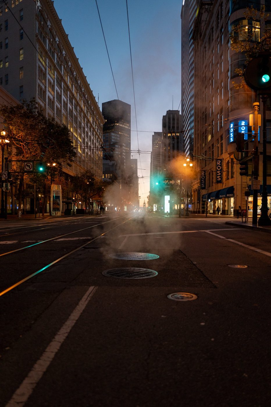 Steam rising near the Ross windows, skyscrapers silhouetted at dawn, San Francisco