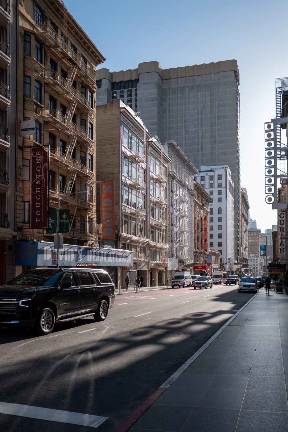 Busy shopping street with fire escapes and the David's Delicatessen sign, San Francisco