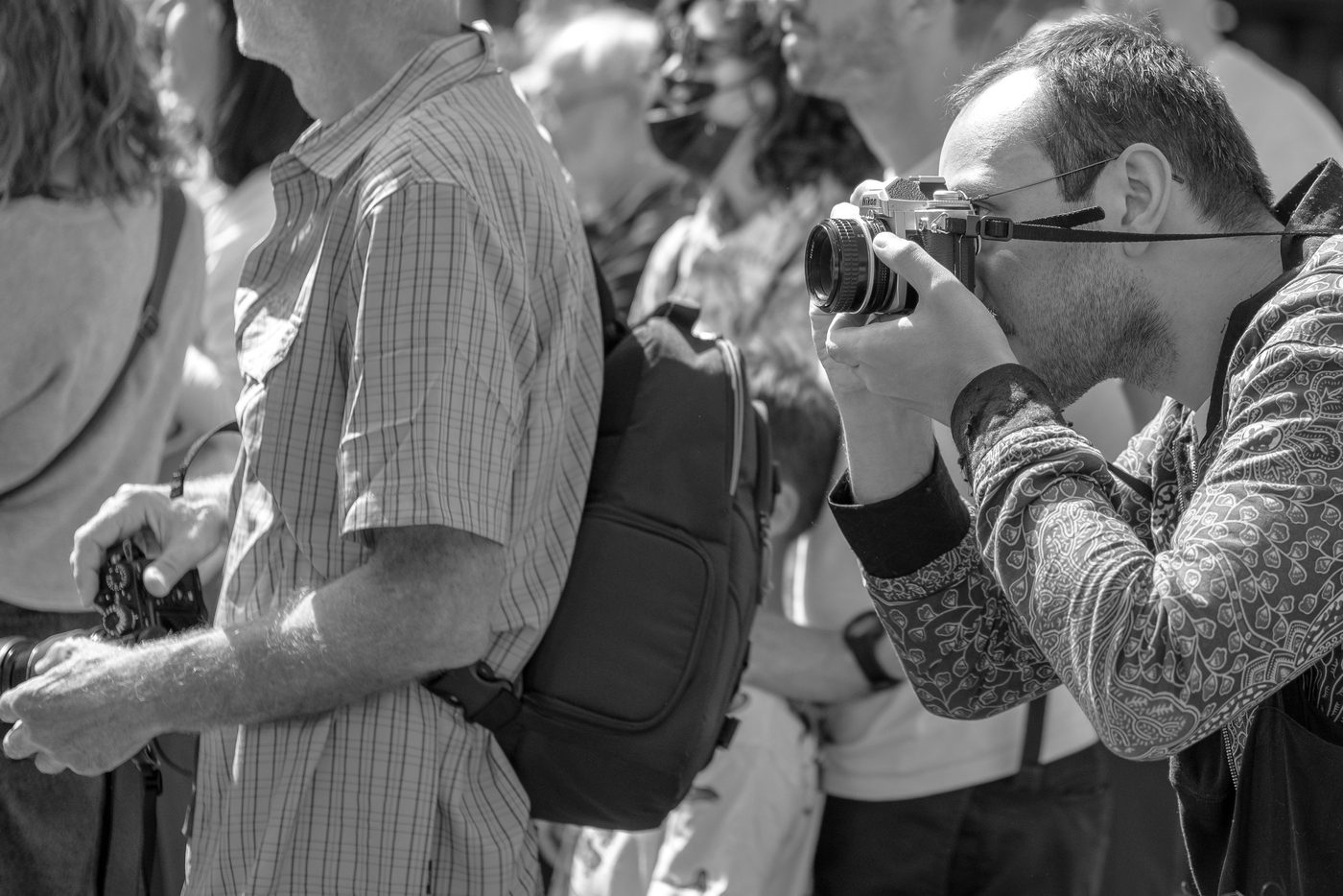 Photographer in action at the Zinneke Parade, Brussels (plate 100)
