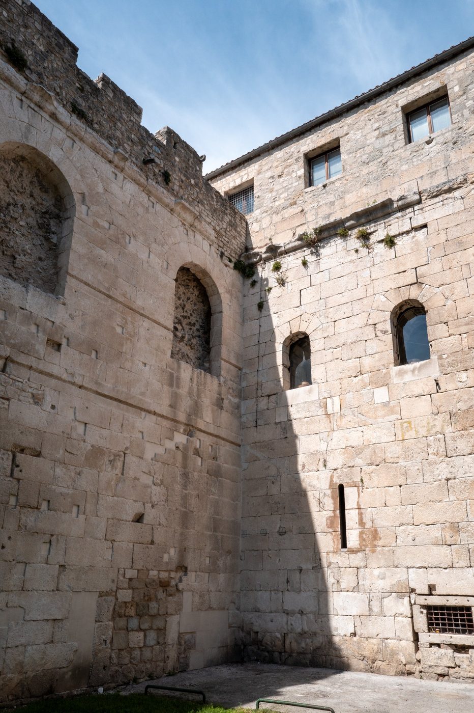 Corner of stone ramparts with arched windows and strong shadow, Split