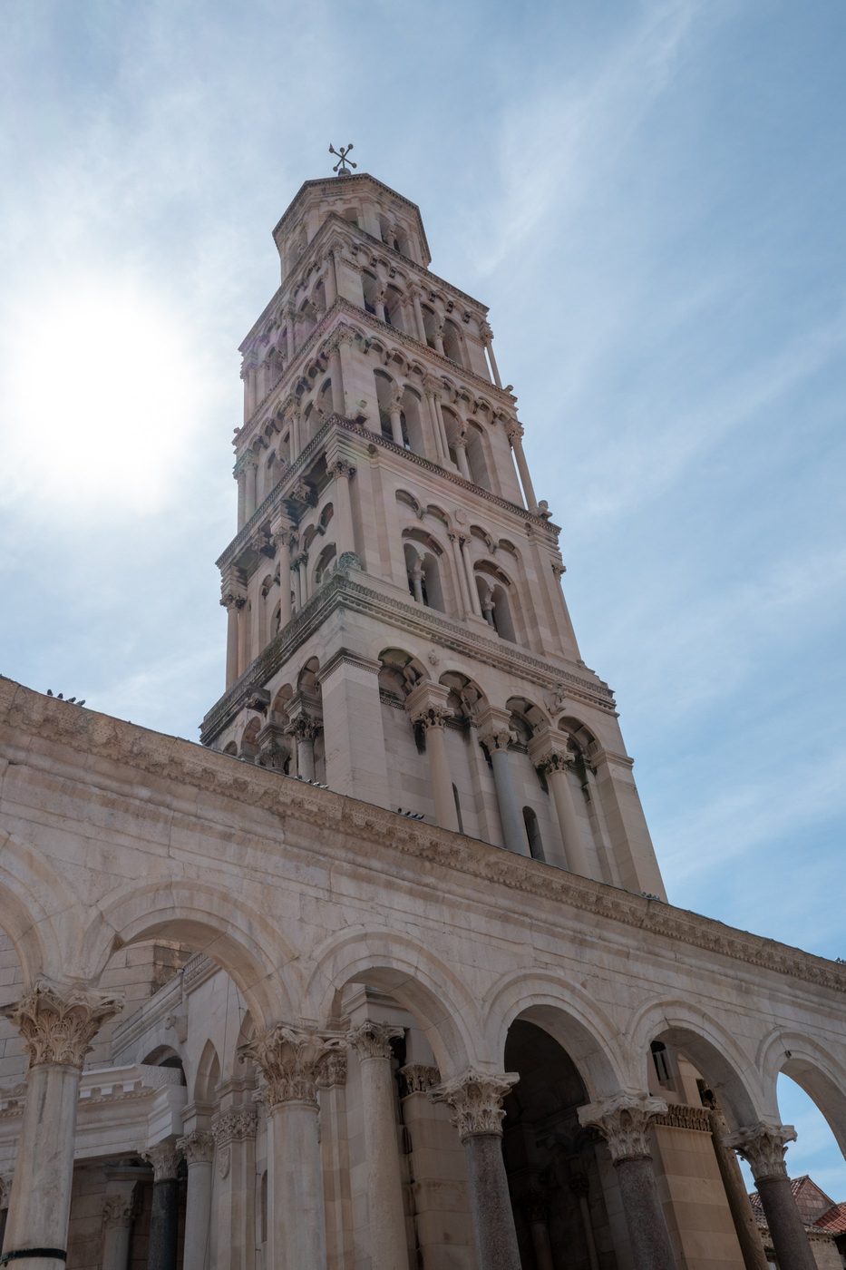 Roman bell tower of the cathedral seen from below in bright backlight, Split