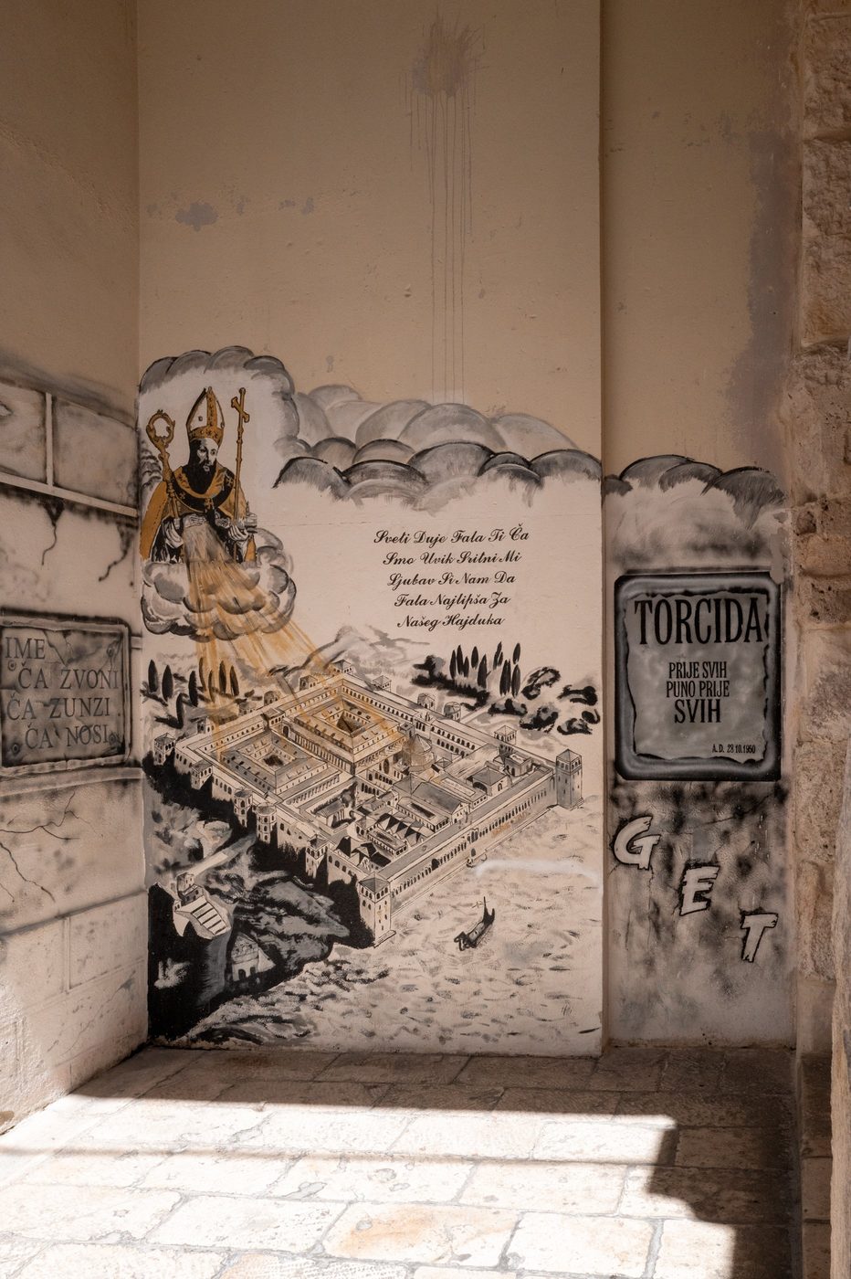 Mural of a patron saint above a drawing of the palace, Split