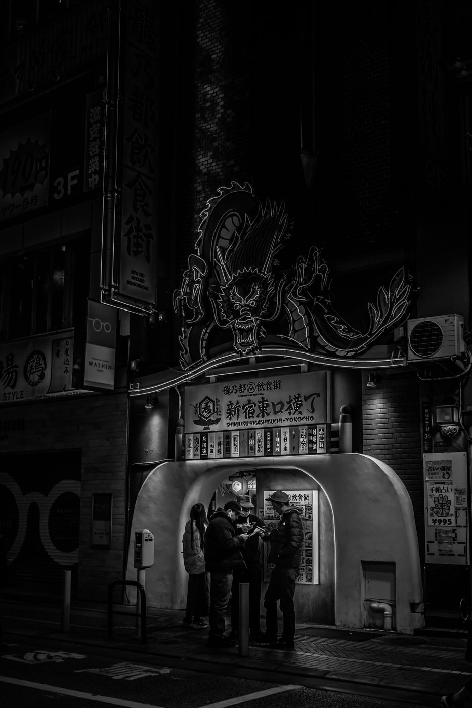 Pedestrians crossing a Kabukicho intersection under the Don Quijote neon signs, Tokyo
