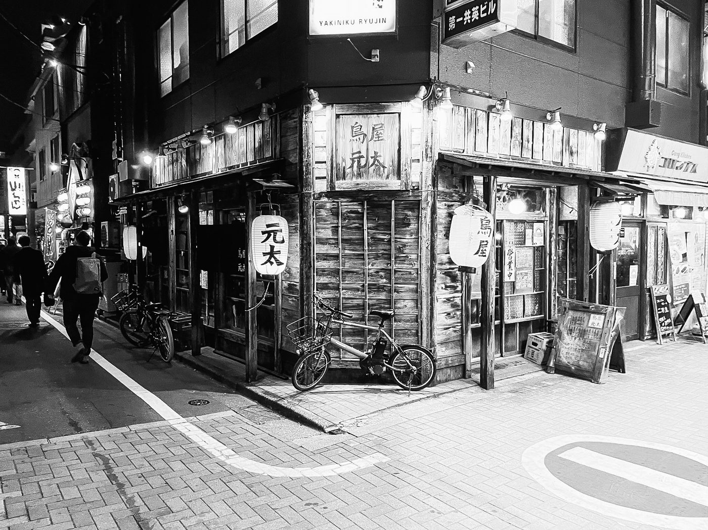 An elderly man standing in front of a traditional izakaya with dark curtains, Tokyo
