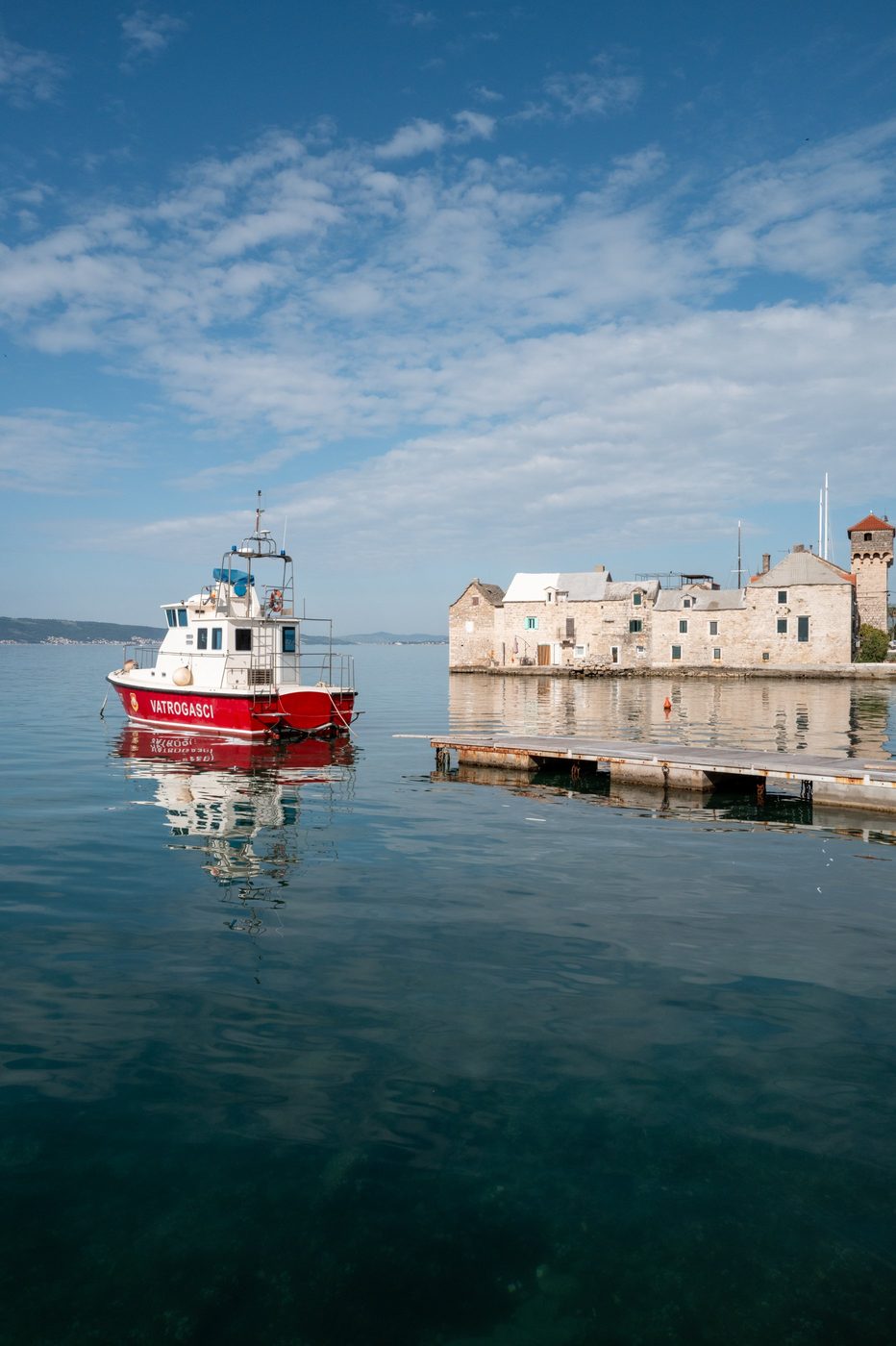 Fire boat moored facing the old stone buildings, Trogir