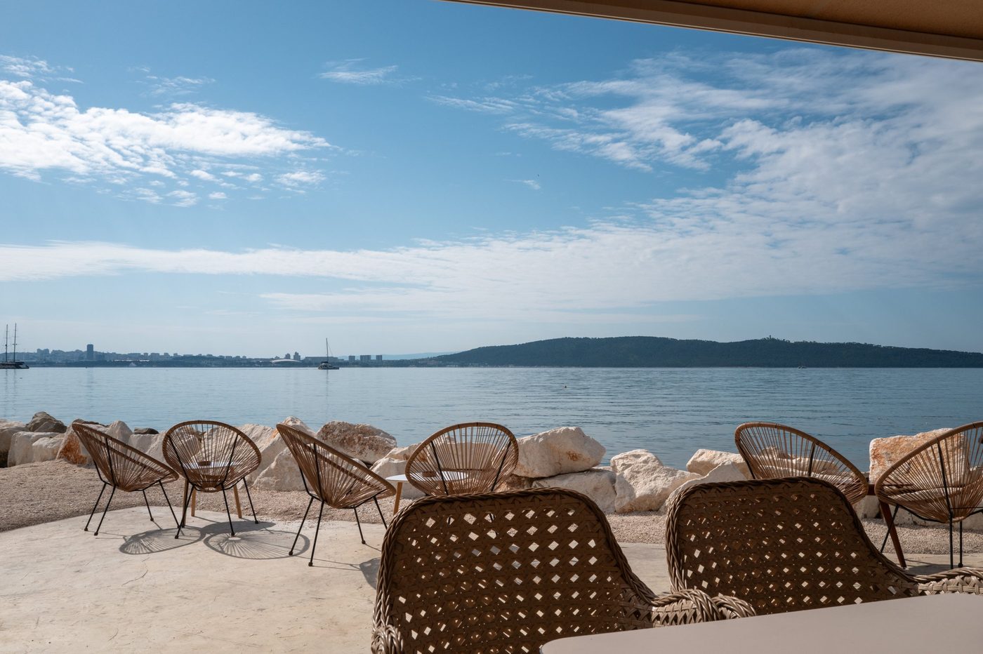 Rattan armchairs on a terrace overlooking the bay, Trogir