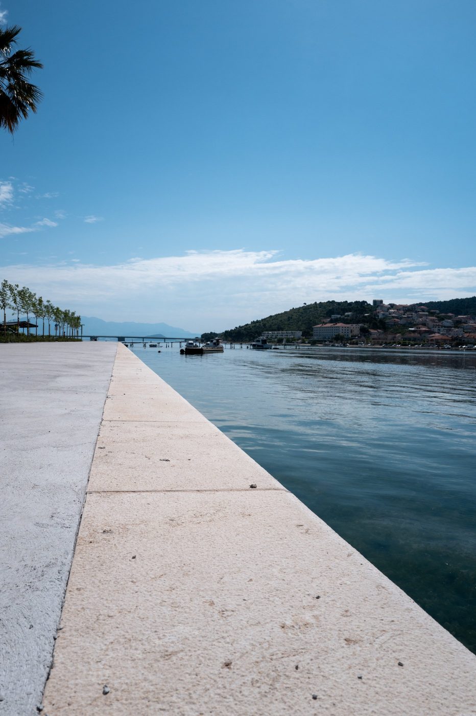 Stone promenade along the palm-lined canal, Trogir