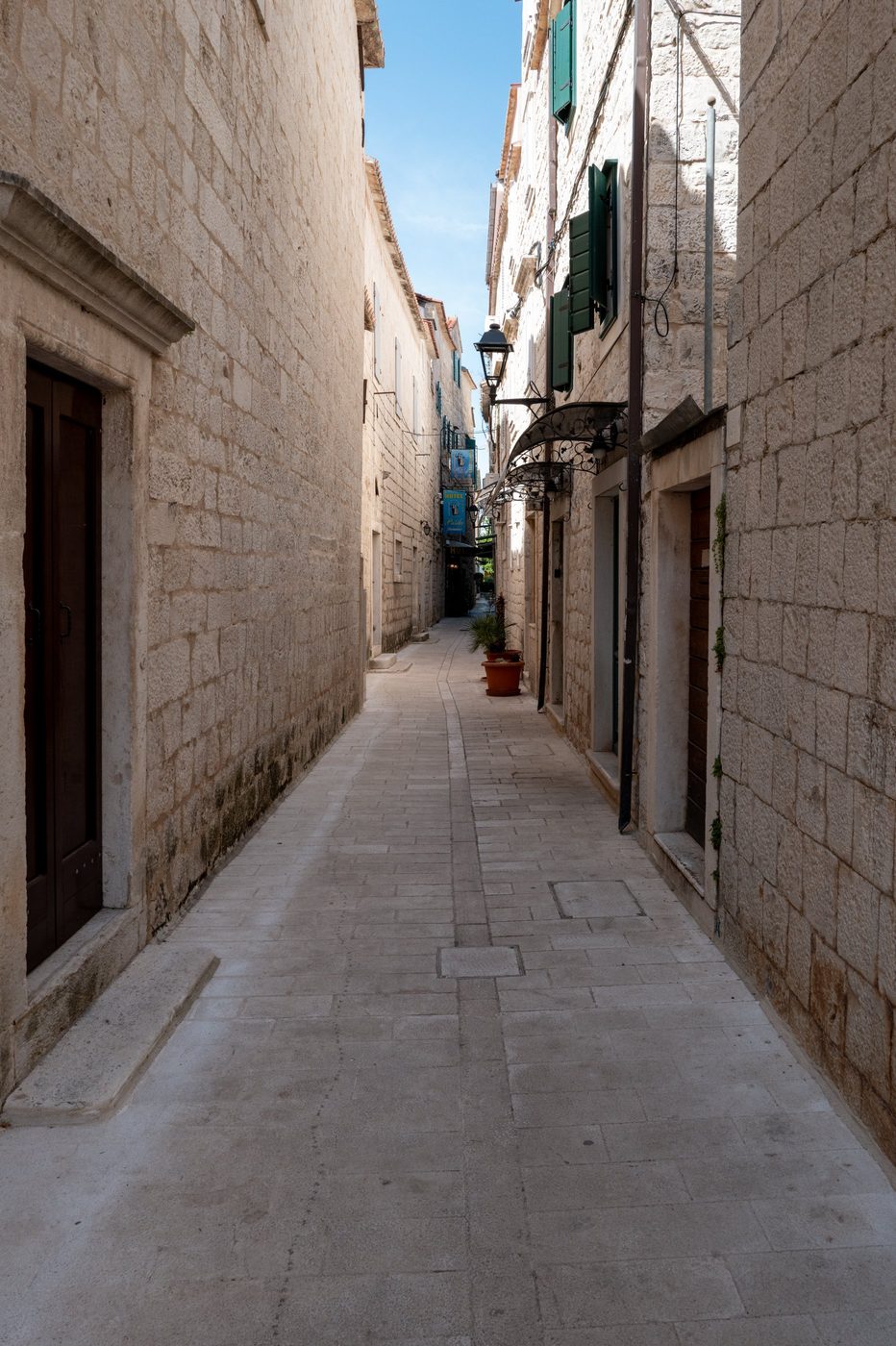 Pedestrian alley lined with shops and flower pots, Trogir