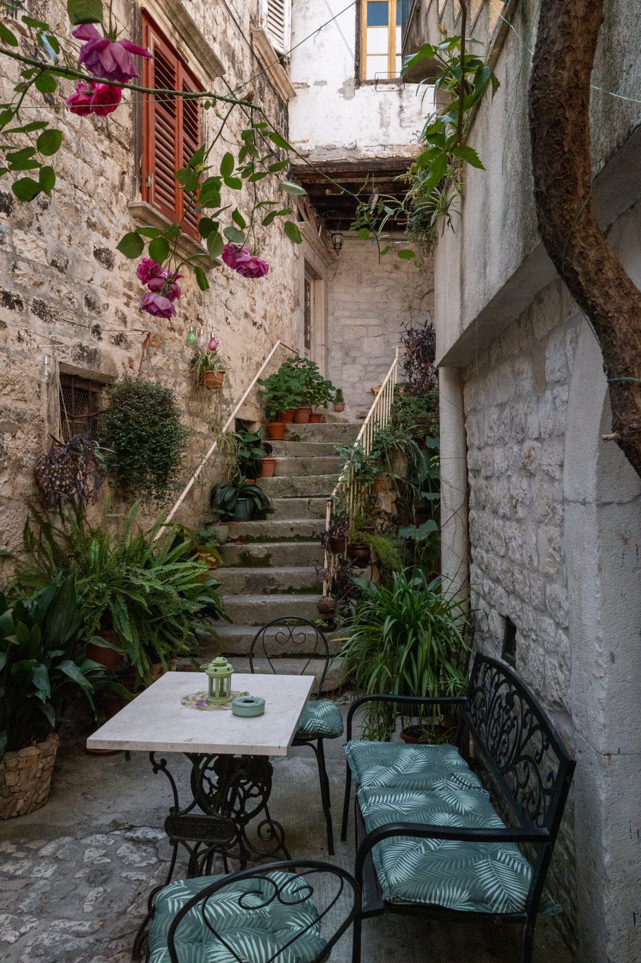 Intimate terrace adorned with roses and a bistro table, Trogir
