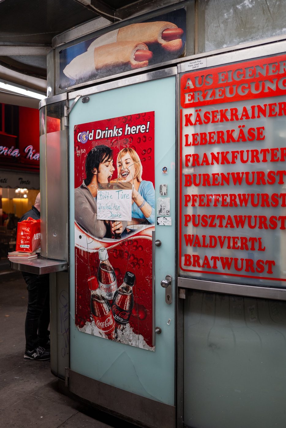 Old Coca-Cola poster on the door of a sausage stand, Vienna
