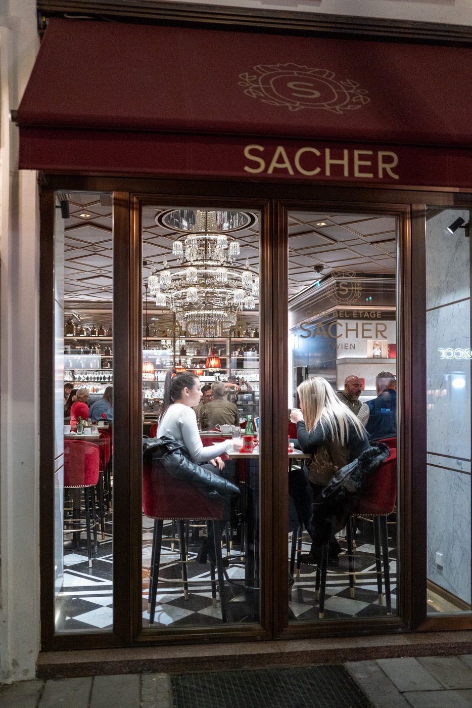 Sparkling chandelier at the entrance of the famous Cafe Sacher, Vienna