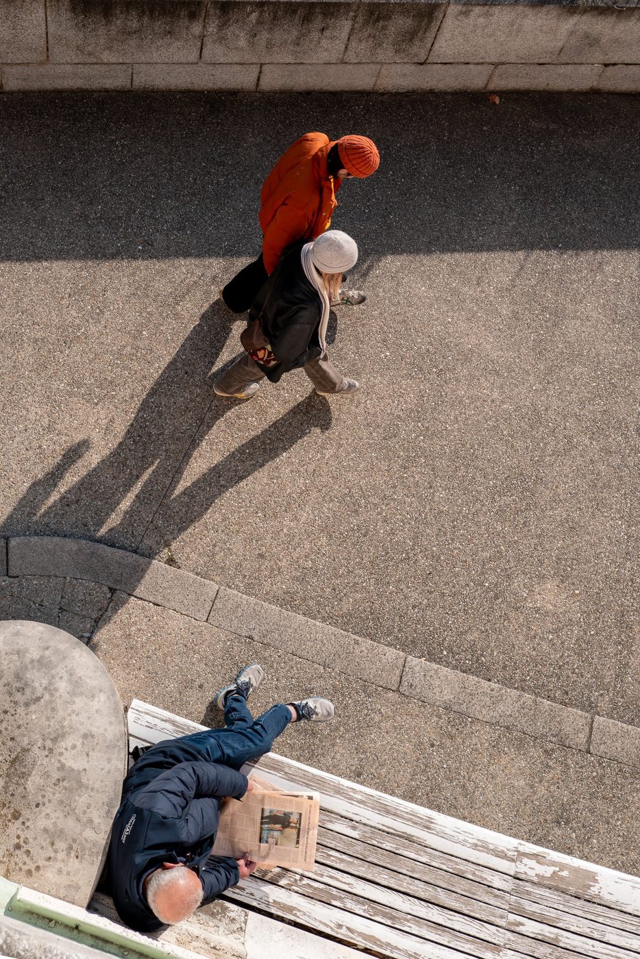 Overhead view of passersby and a man reading a newspaper, Vienna