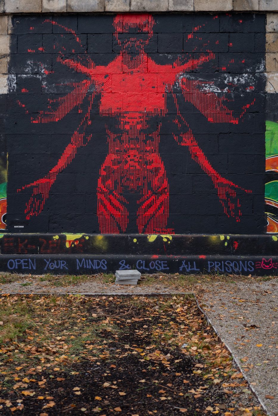 Pixelated red mural above a political slogan, Vienna