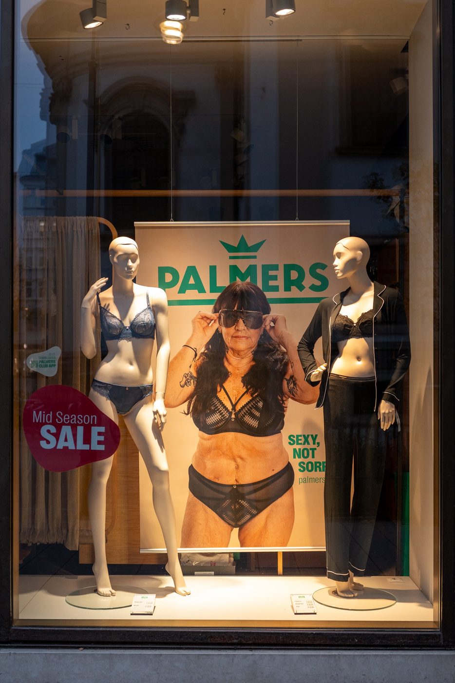 Palmers shop window mixing mannequins and an unfiltered poster, Vienna