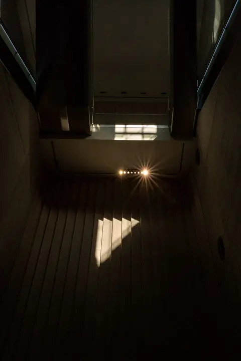 A ray of sunlight falling to the bottom of a concrete shaft, Bergen