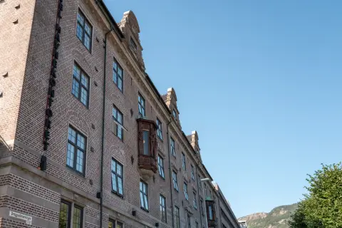 A brick facade with small-paned windows seen from below, Bergen