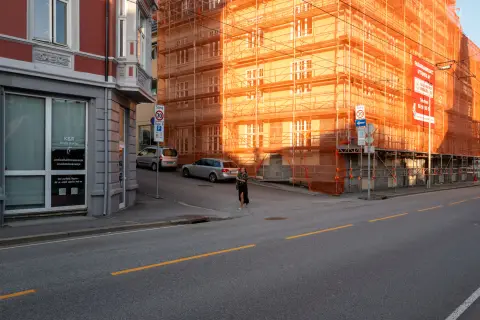 A building under scaffolding set ablaze by the setting sun, Bergen
