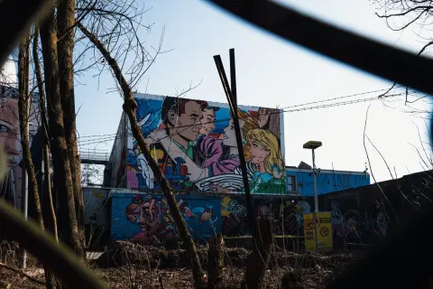 Fresque murale façon bande dessinée pop art vue à travers des fils barbelés, Berlin