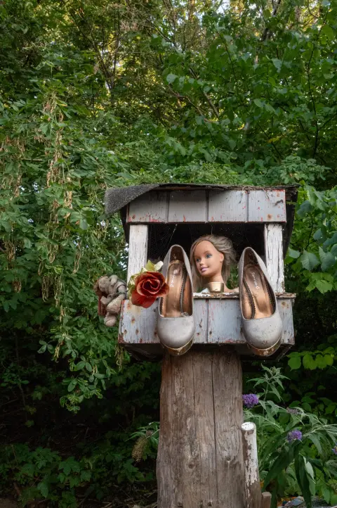 A doll’s head and high heels in a wooden birdhouse, Christiania, Copenhagen
