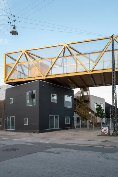 A yellow footbridge set above a black house, Copenhagen