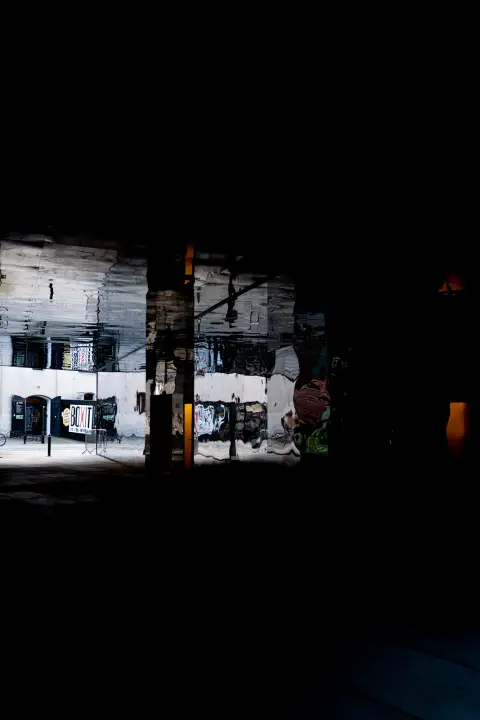 A lit scene at the end of a passage plunged into darkness, Copenhagen