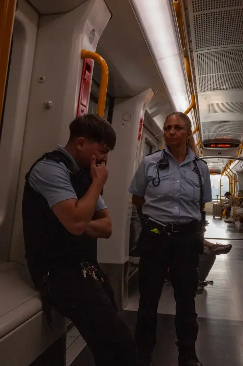 Two uniformed officers standing in a metro carriage, Copenhagen