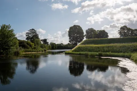 The moats and grassy ramparts of the Kastellet under a summer sky, Copenhagen