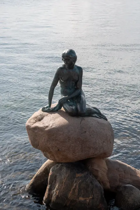 The Little Mermaid on her rock, facing the glittering water, Copenhagen