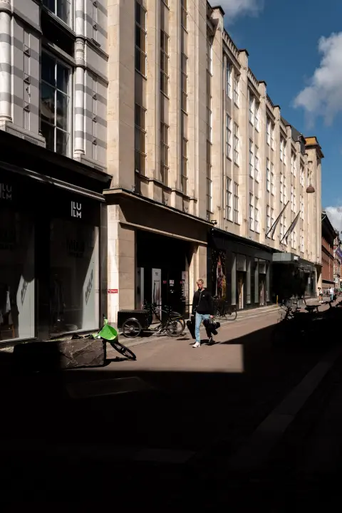 A shopping street cut by deep shadows, Copenhagen